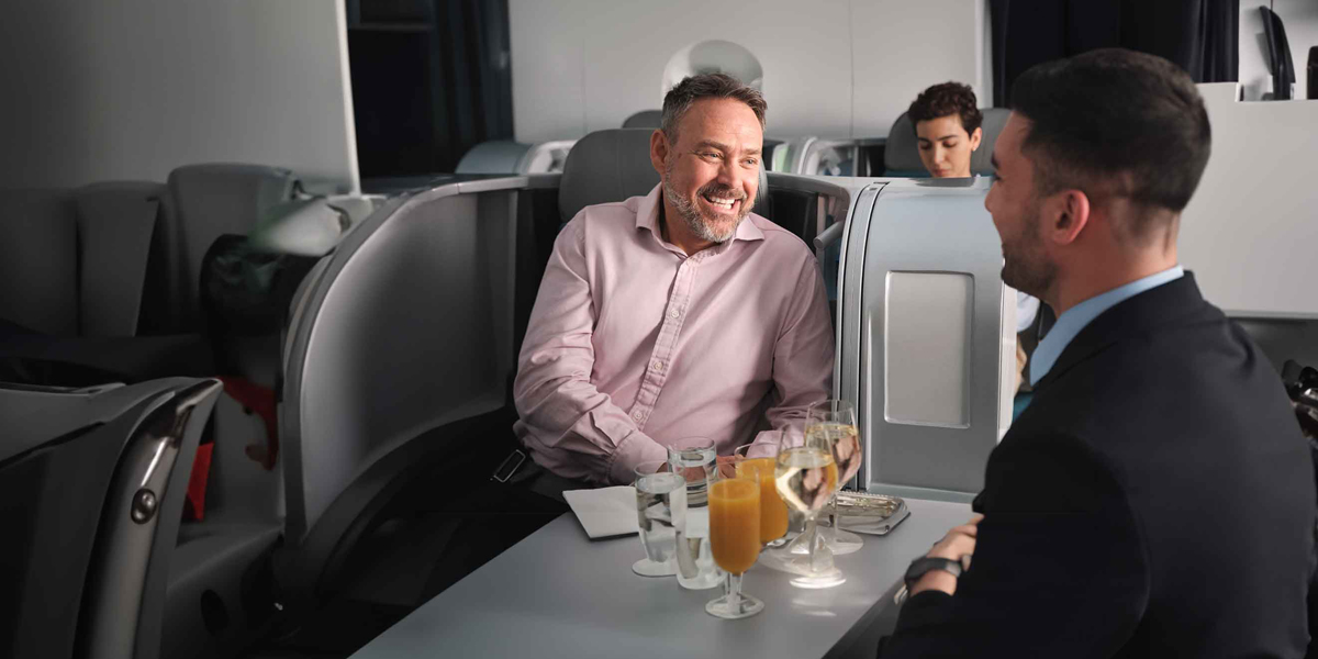 Two well-dressed men get down to business aboard Aer Lingus