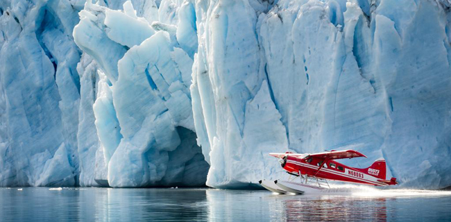 Stunning photo of a sea plane alongside a glacier in Anchorage, Alaska.