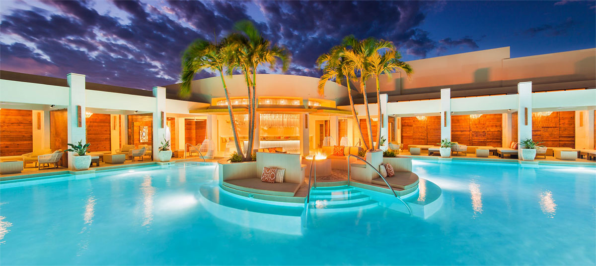 Pool surrounded by luxe private cabanas