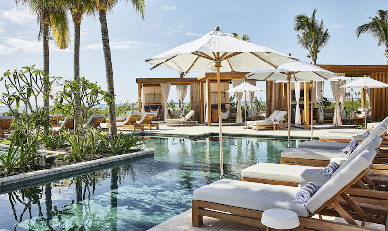 Oceanfront pool with loungers and cabanas