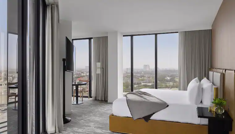 1 King Bed Large Corner Room, at C. Baldwin, Curio Collection by Hilton